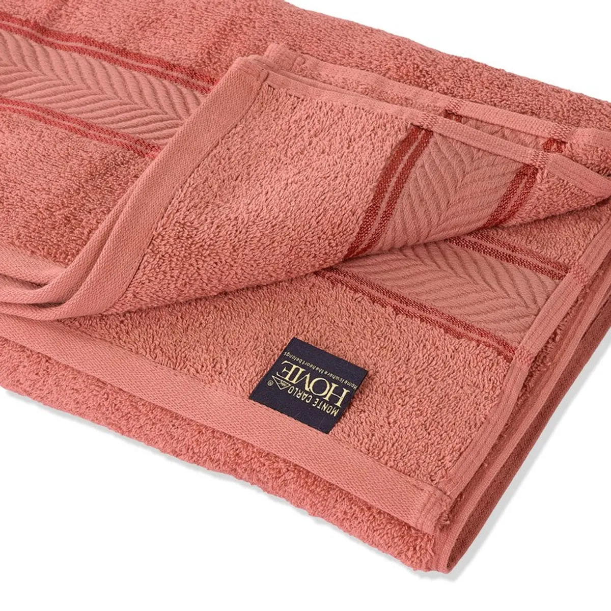 Close view of the peach towel's soft pile, border and sewn label.