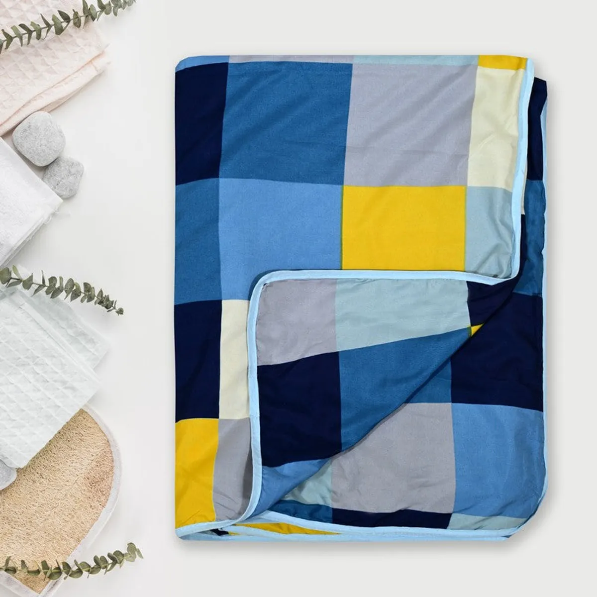 Folded checked dohar showing its colourful geometric pattern