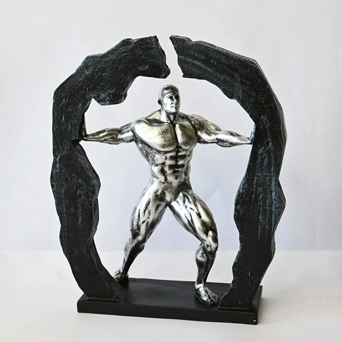 Silver Heracles-style figurine showpiece on a black base against a white background