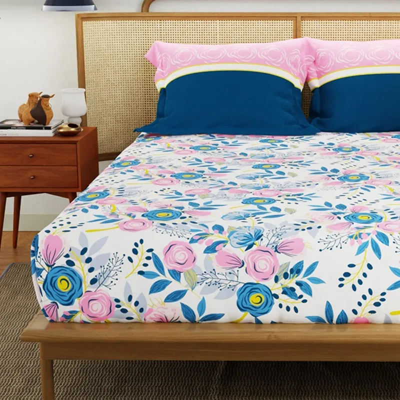Front view of floral bedsheet with pink and blue pillow covers