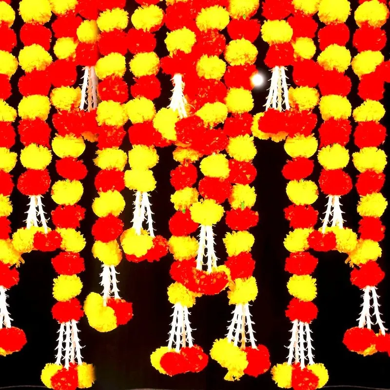 Detailed view of red and yellow toran strings with white tassel ends