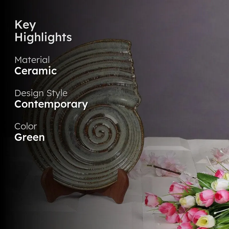 Glossy green and brown spiral ceramic platter displayed upright with flowers
