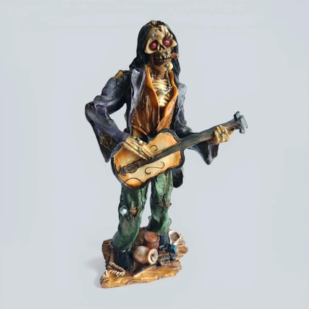 Angled front view of the zombie guitarist showpiece on a light grey background