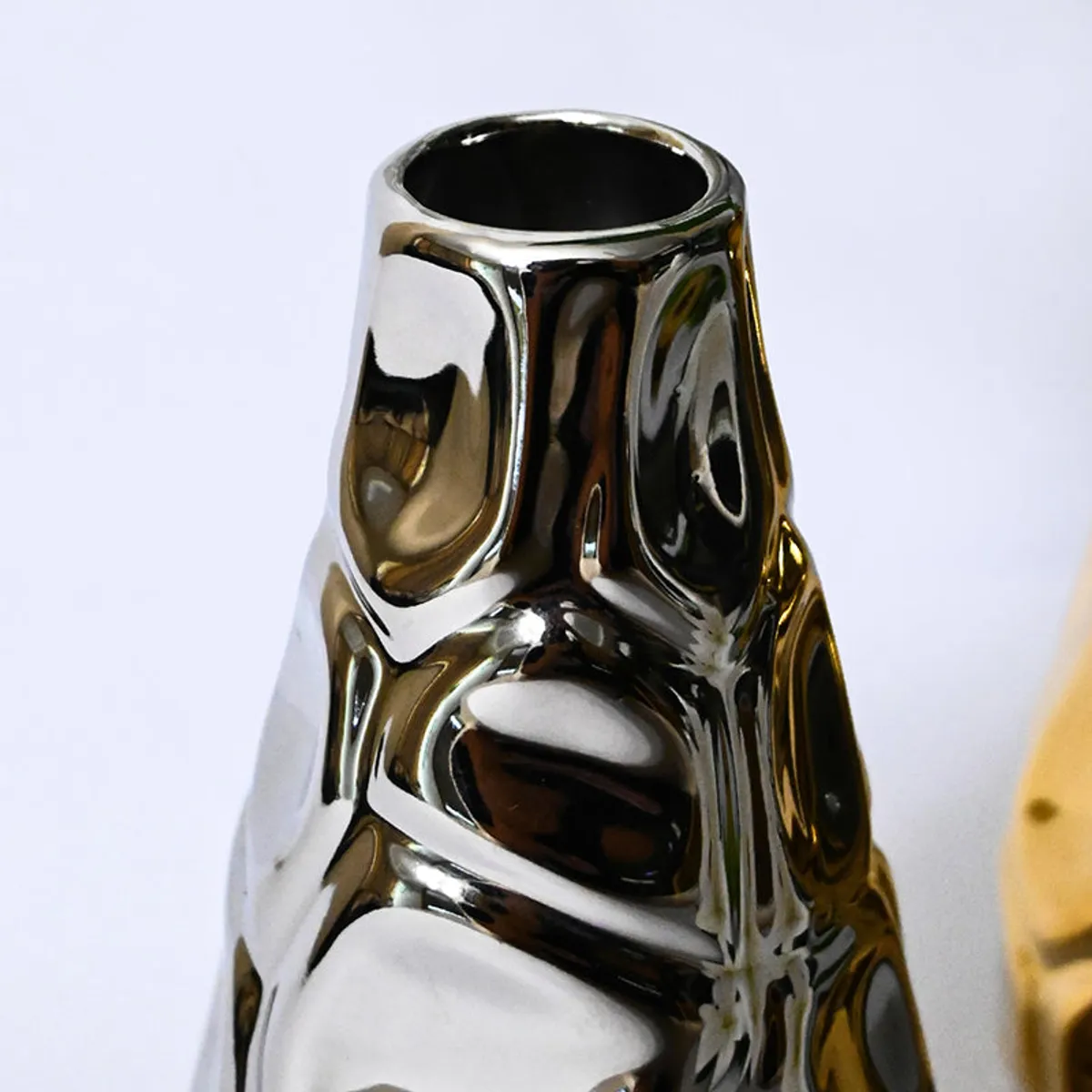 Close-up of the silver vase with a reflective textured surface