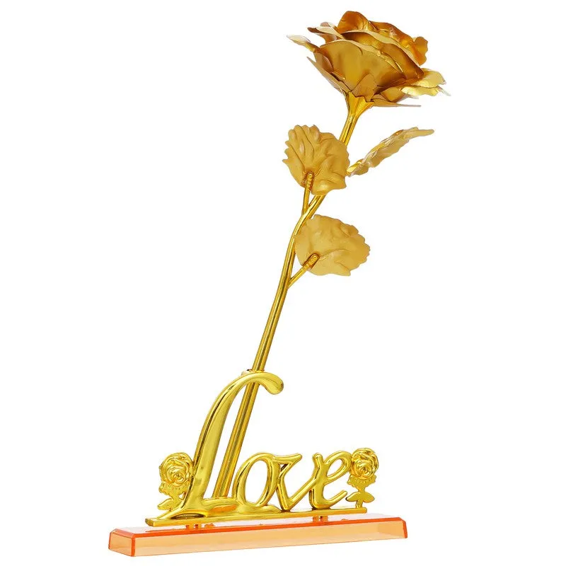 Single gold rose ornament with love-shaped base on white background