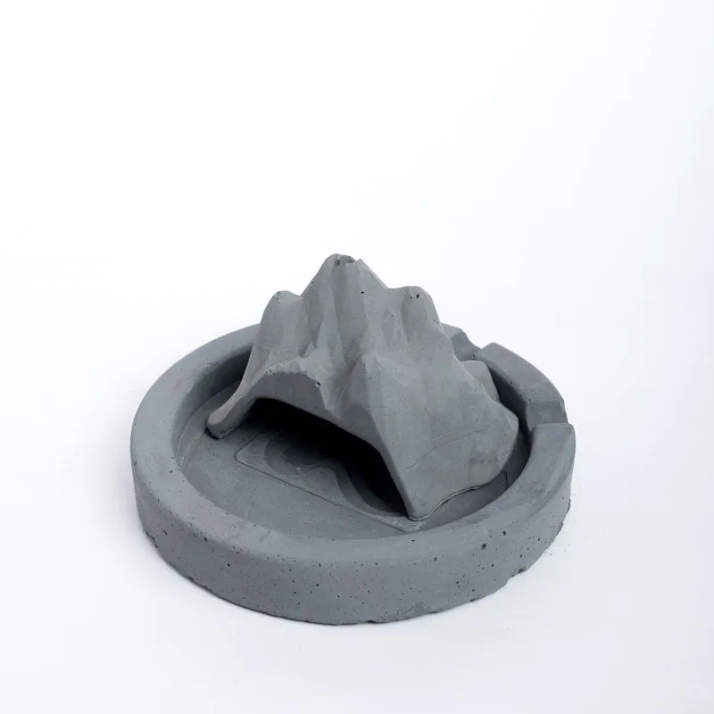 Grey sculptural mountain ash tray shown against a white background