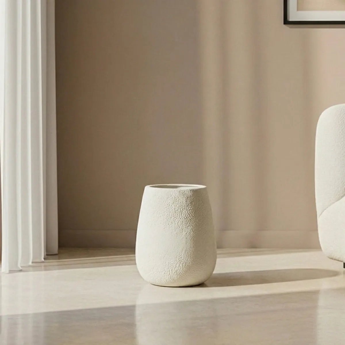 White planter displayed on a sunlit floor in a contemporary room