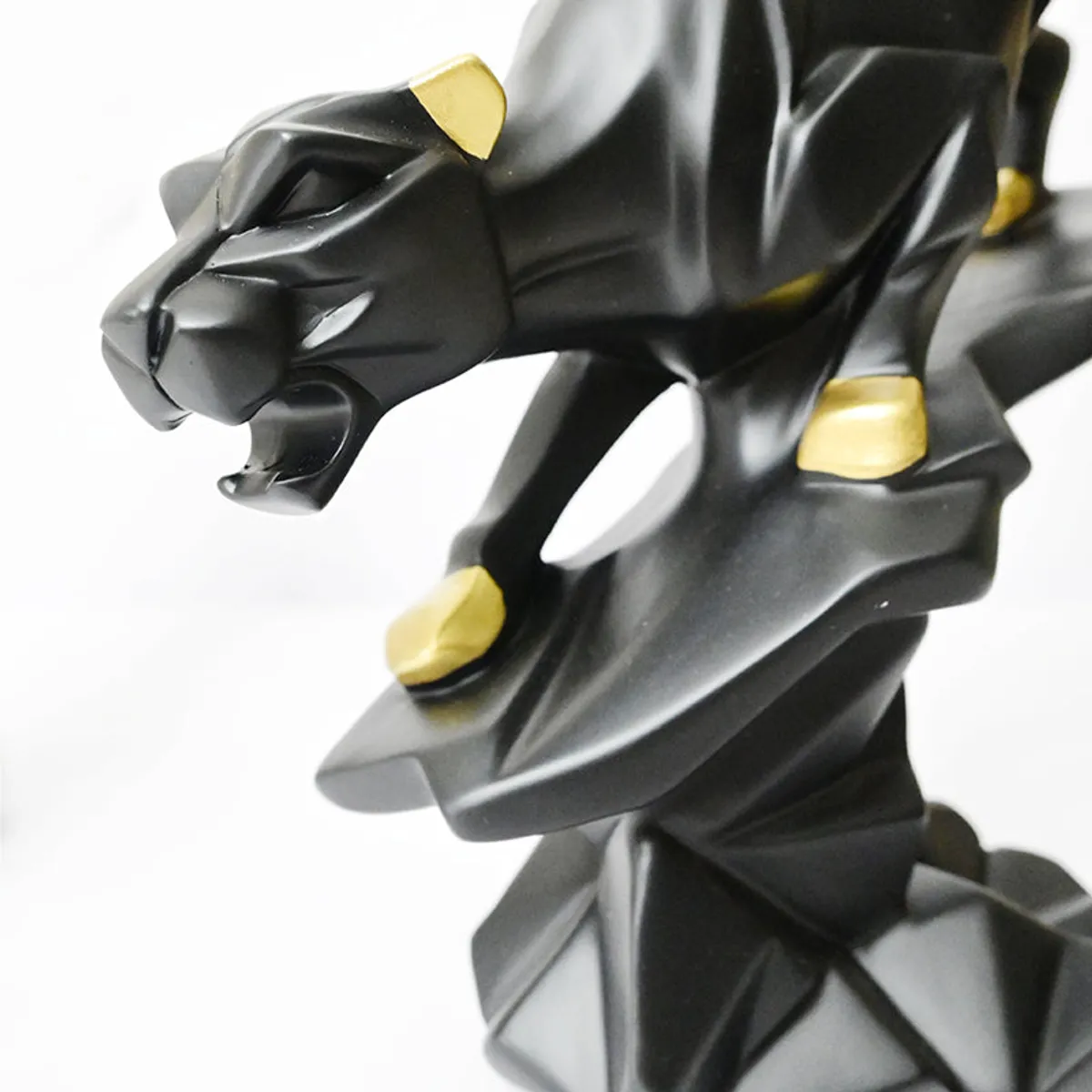 Close-up of the panther head and front section with gold accents