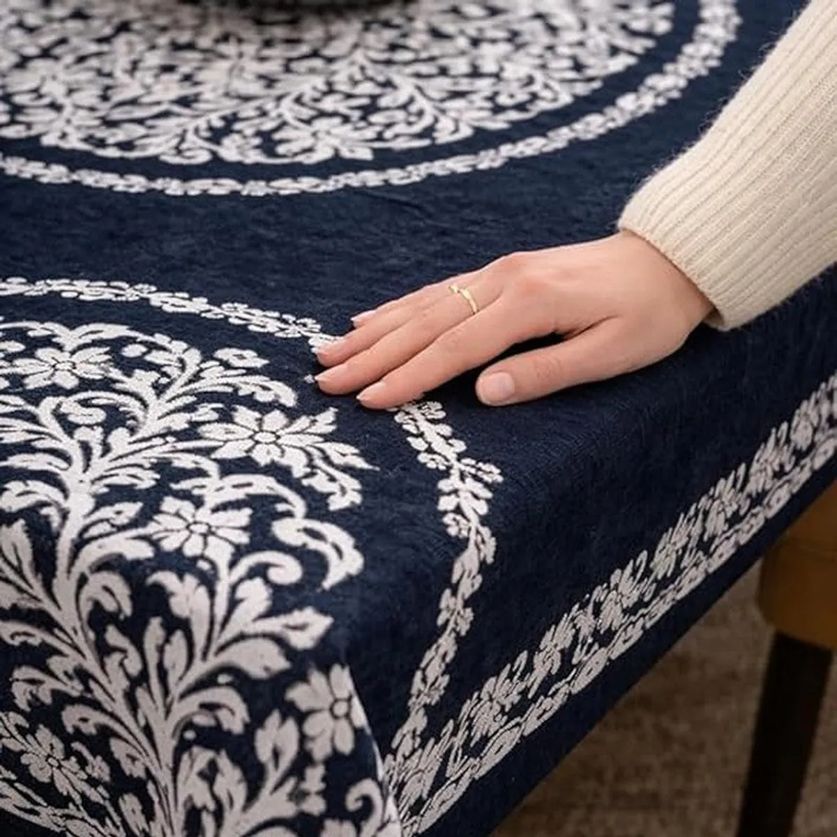 Detailed view of the soft blue and white patterned table cover fabric