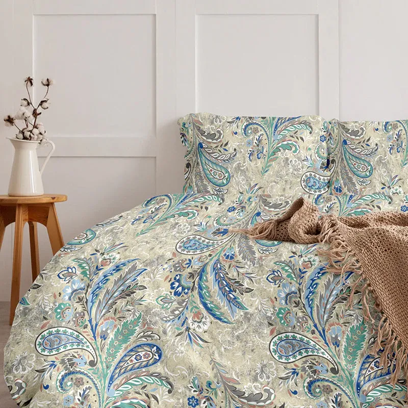 Blue and beige paisley floral duvet cover styled on a bed