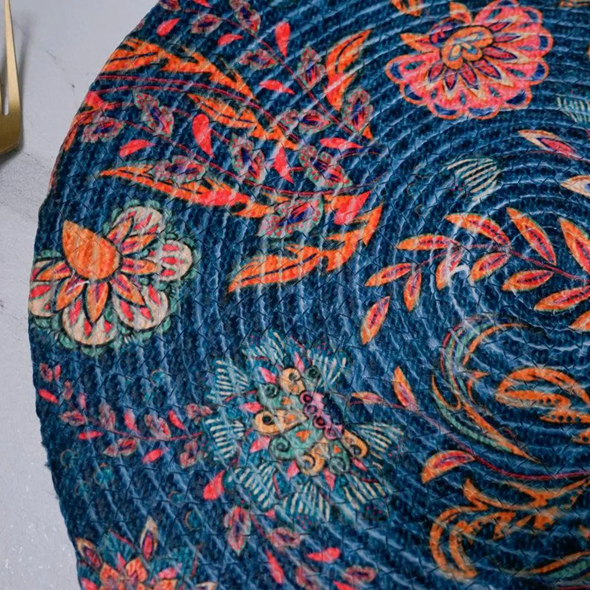 Close-up of the printed floral pattern and textured surface on a blue table mat