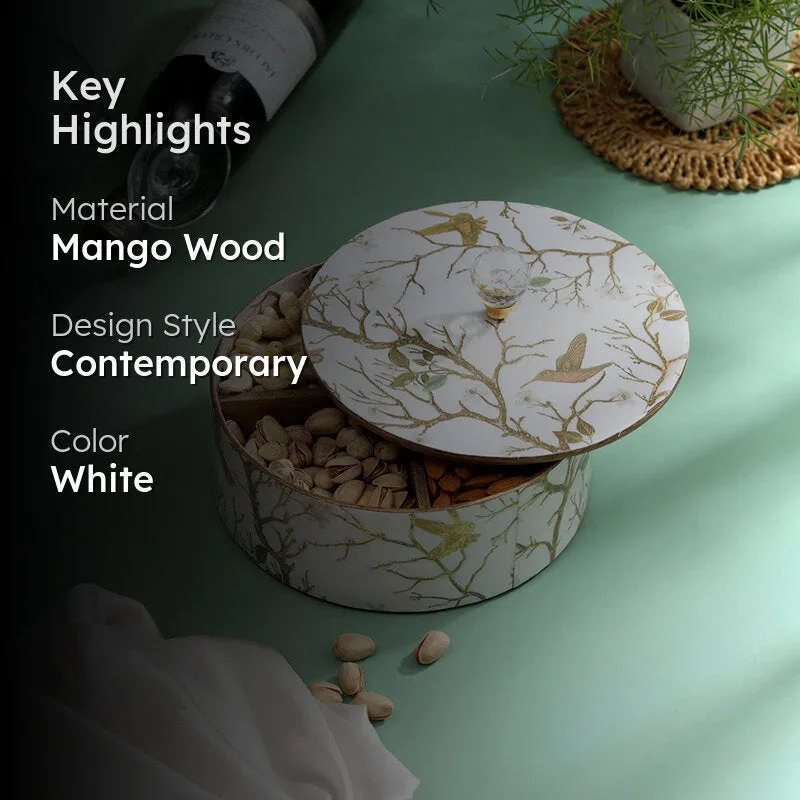White decorative dryfruit box styled with nuts on a green surface