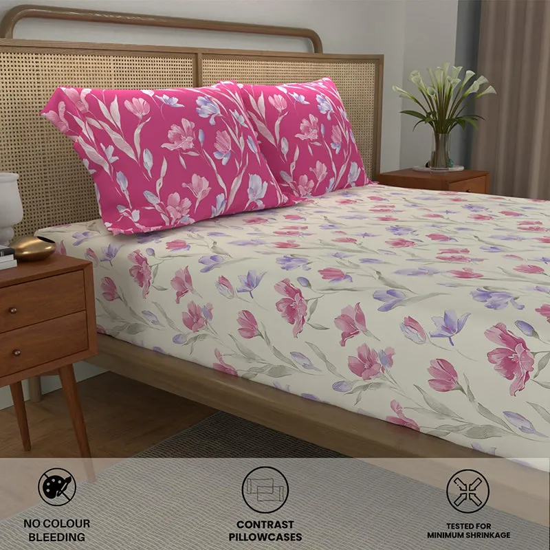 Angled view of floral cream bedsheet and pink floral pillow covers