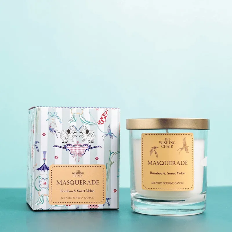 Aqua glass candle with metallic lid placed beside its printed box
