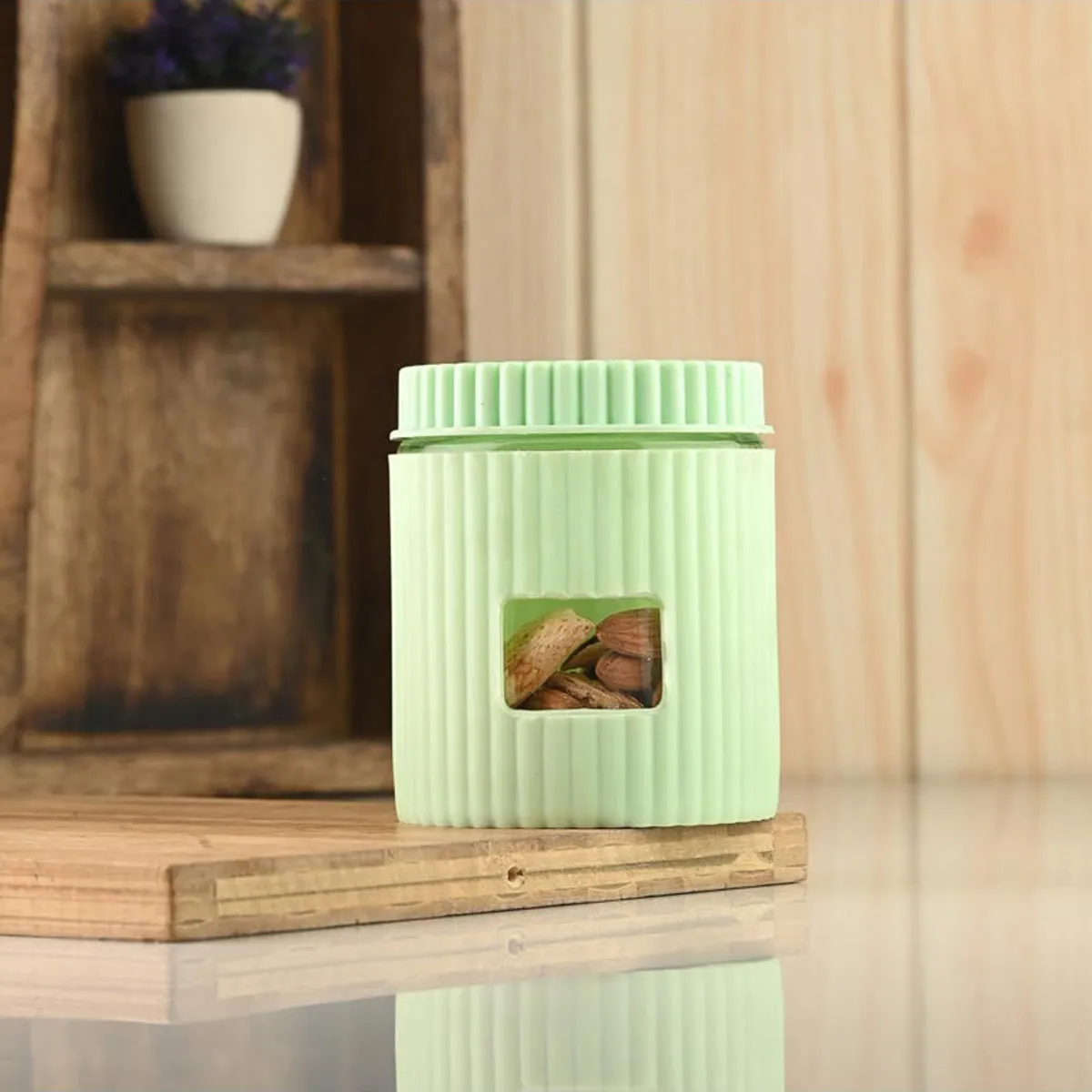 Closed mint-green ribbed storage jar displayed on a wooden board