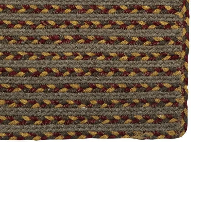 Close-up of brown woven jute bath mat corner with geometric striped pattern