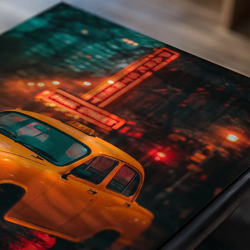 Close-up of a yellow car poster against a rainy city night scene