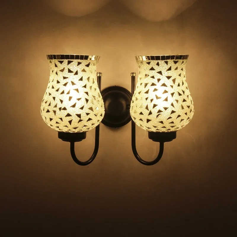 Close front view of lit dual glass wall lamp