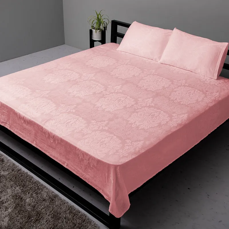Pink floral jacquard duvet cover styled on a bed with matching pillows.