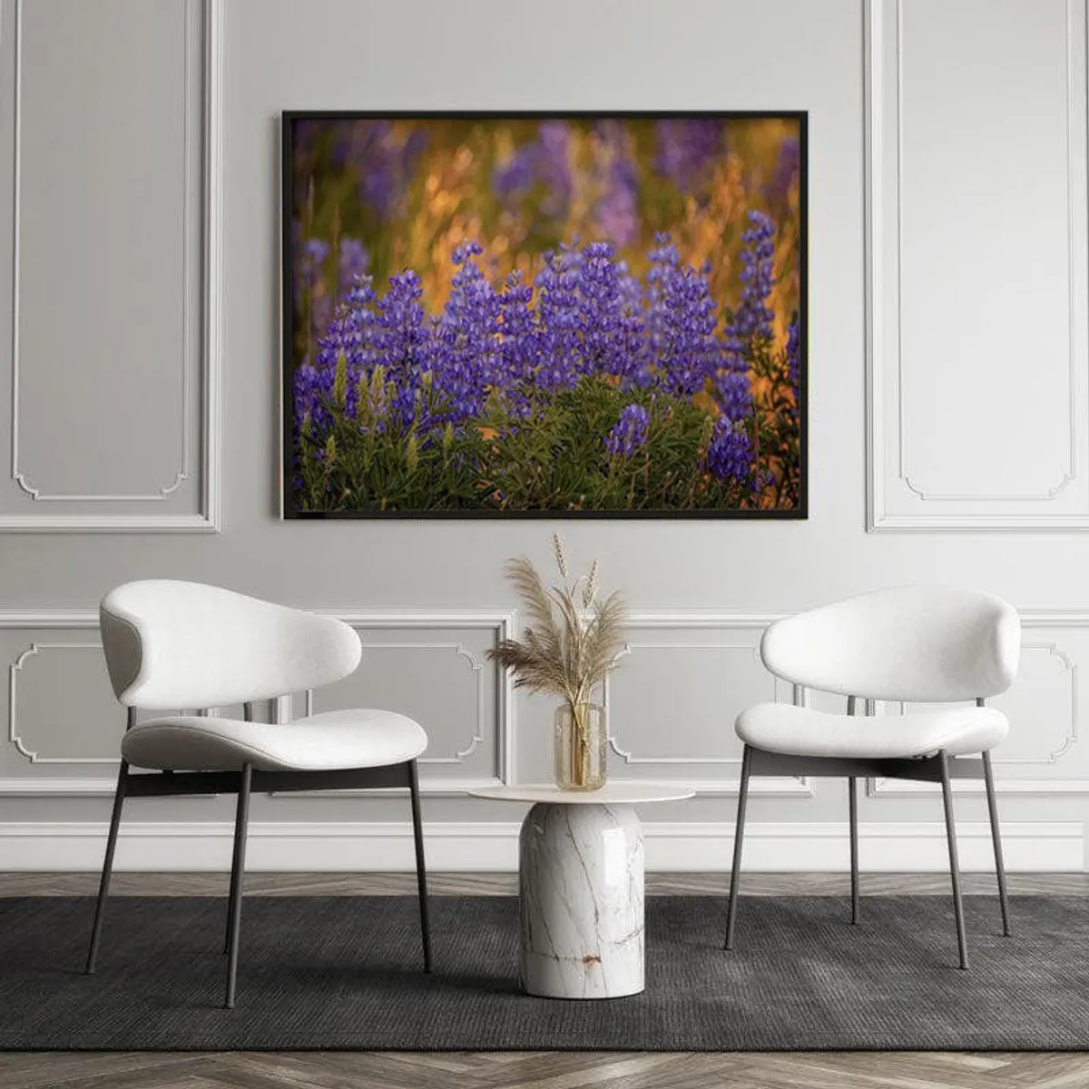 Framed wildflower canvas displayed between two white chairs