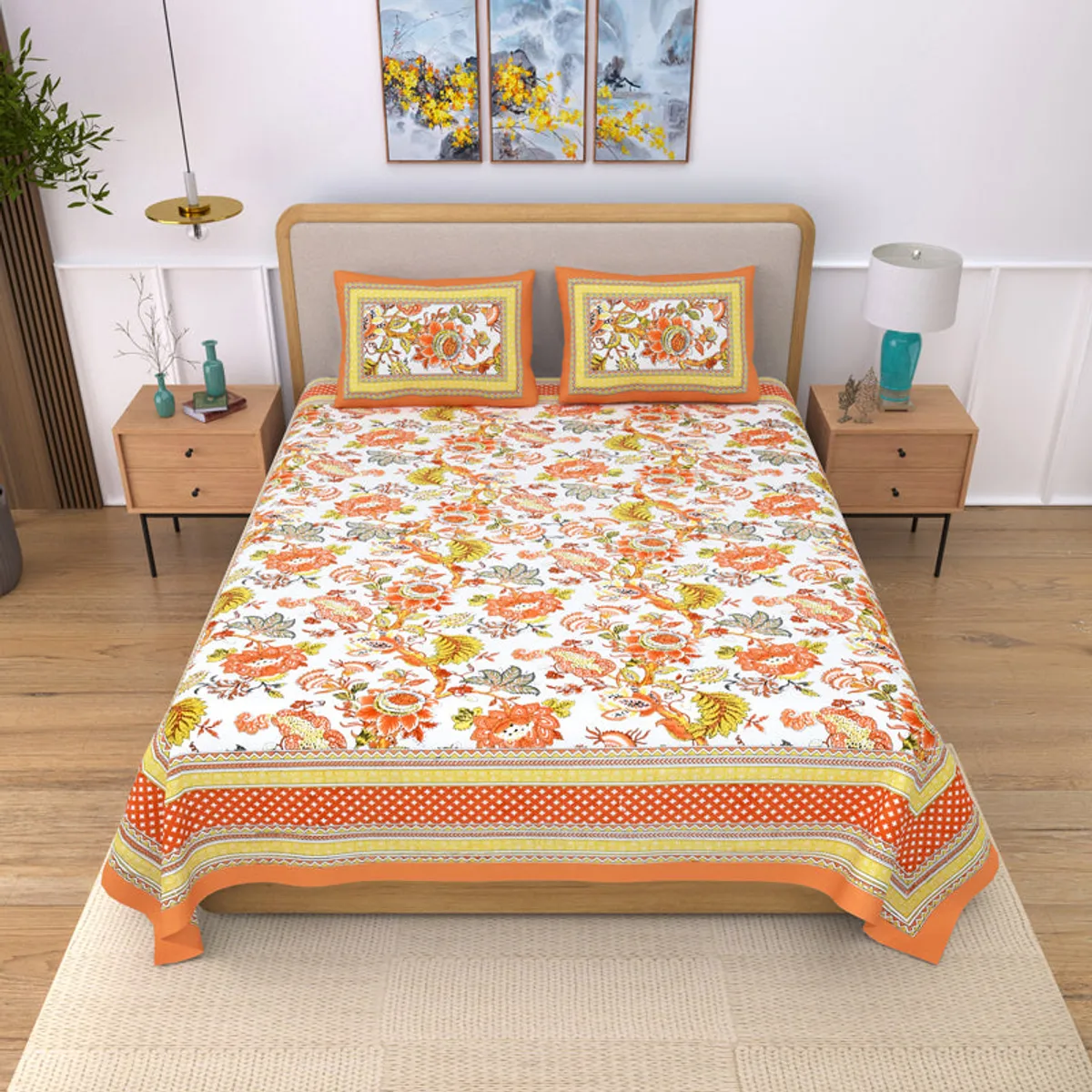 Orange floral cotton bedsheet styled on a double bed with matching pillow covers