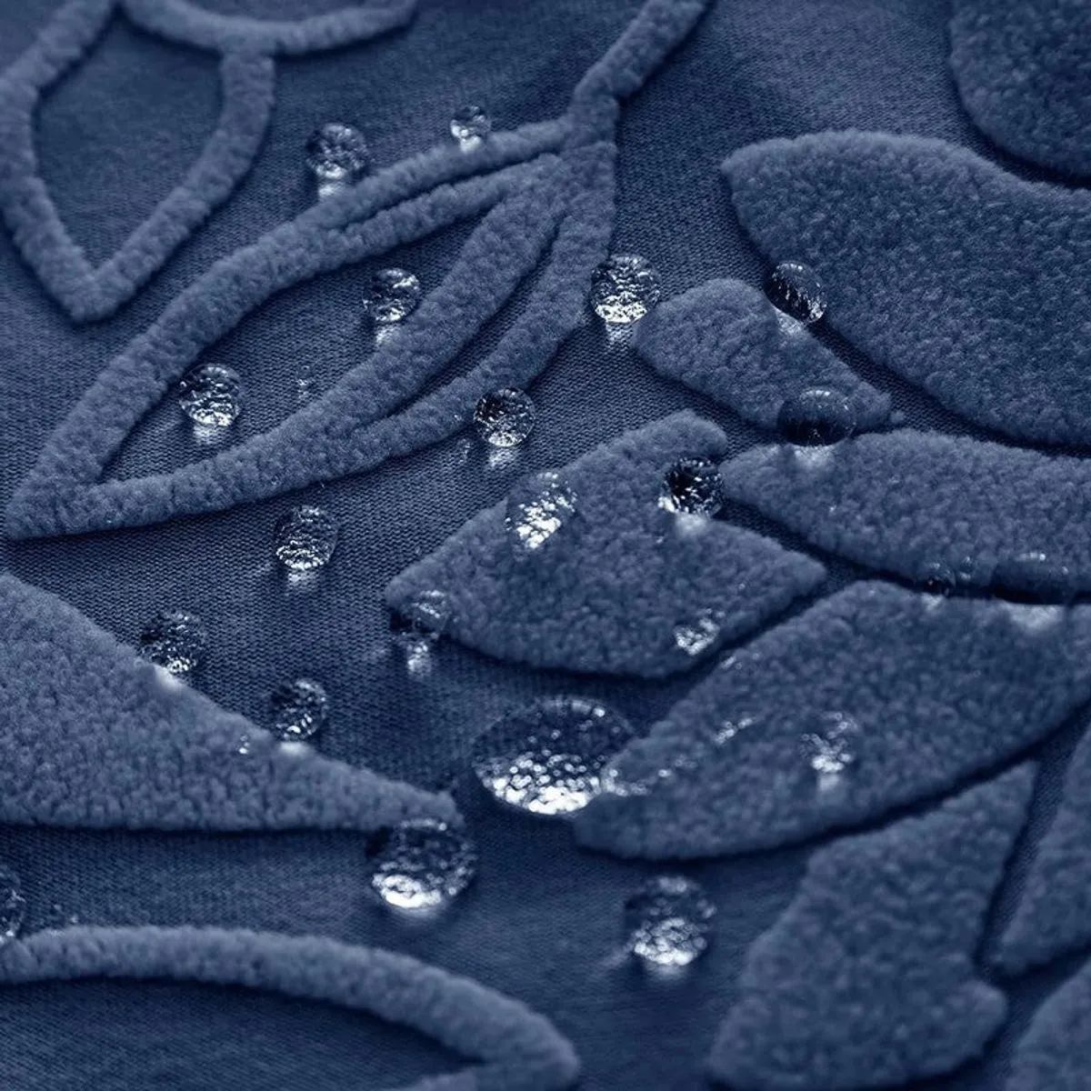 Close-up of blue textured floral fabric with water droplets