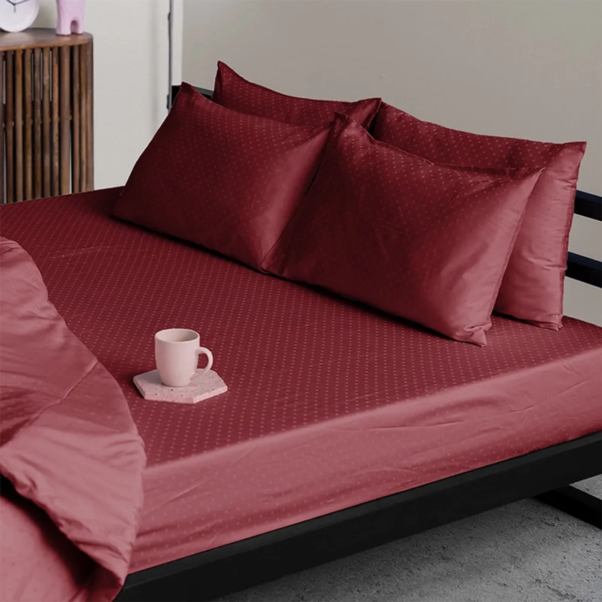 Maroon duvet cover styled on a contemporary bed with matching pillows