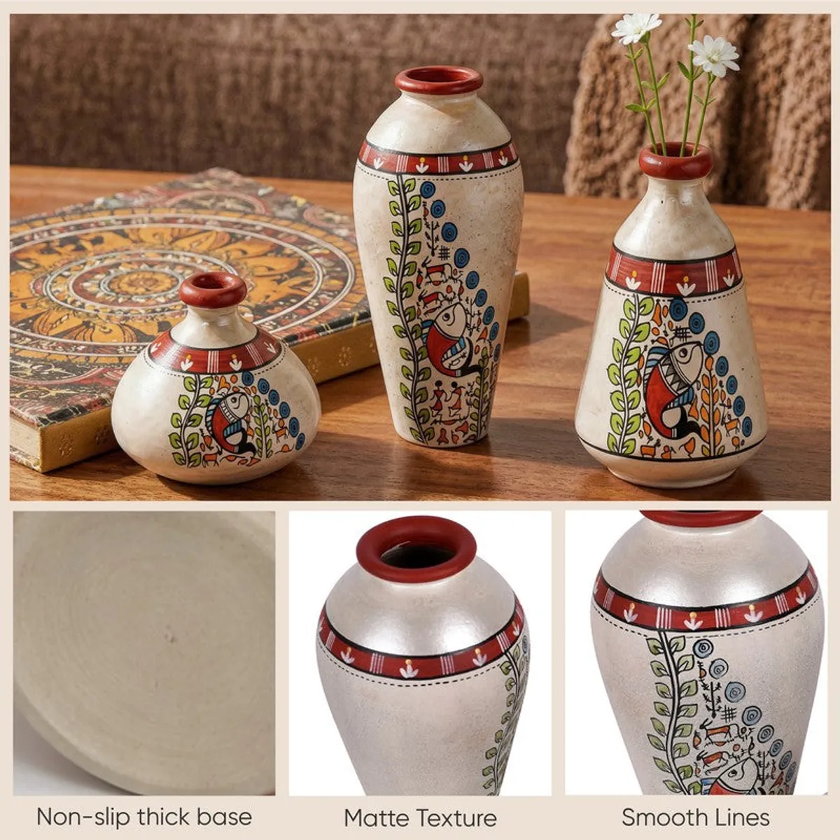 Three decorative terracotta vases with painted tribal motifs on a wooden table