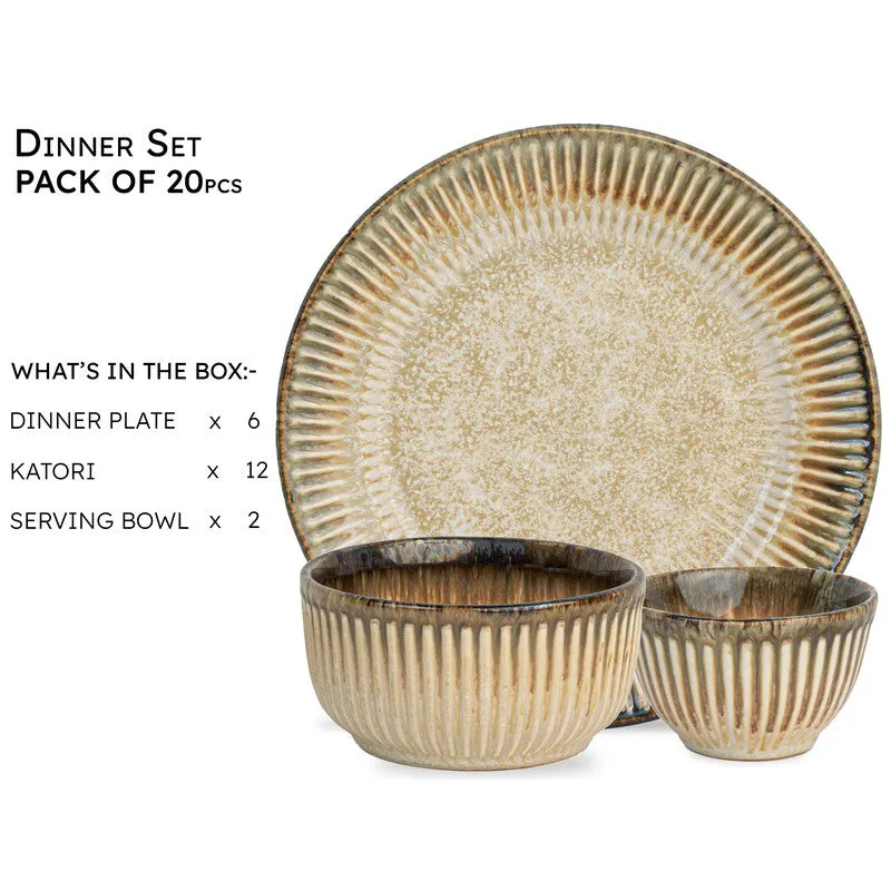 Close display of a beige ceramic dinner plate and serving bowls