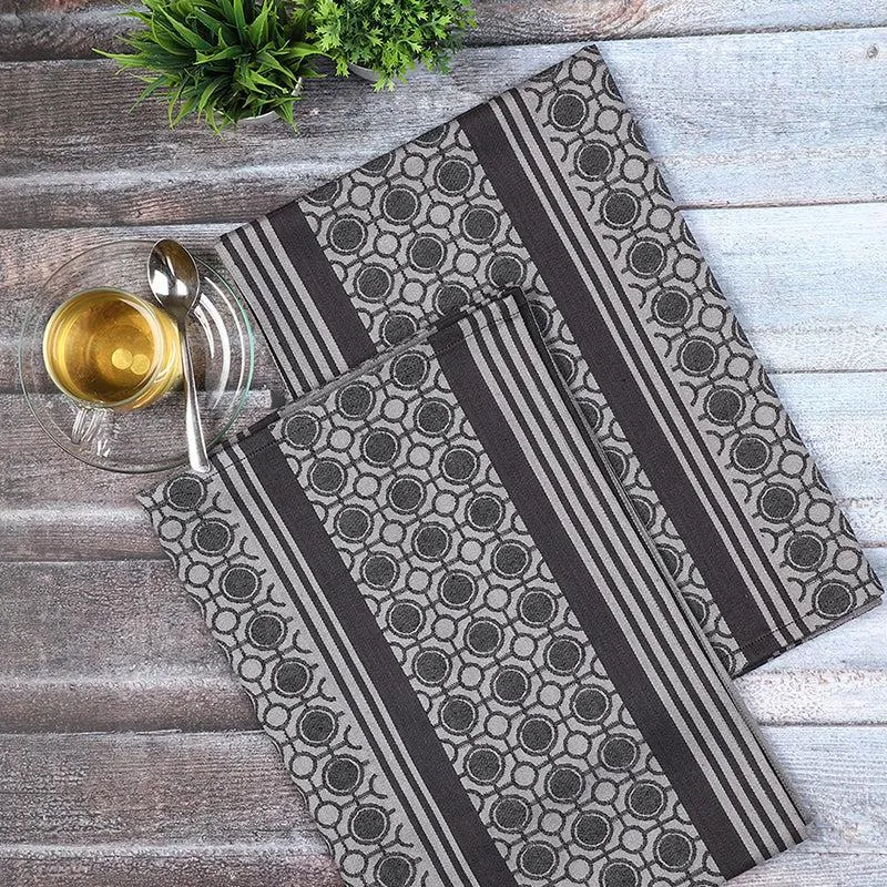 Set of two black and grey geometric kitchen towels laid flat
