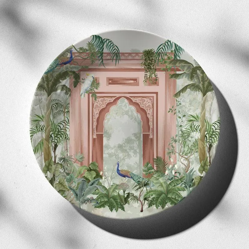 Round decorative wall plate with Mughal arch, peacocks and lush green foliage