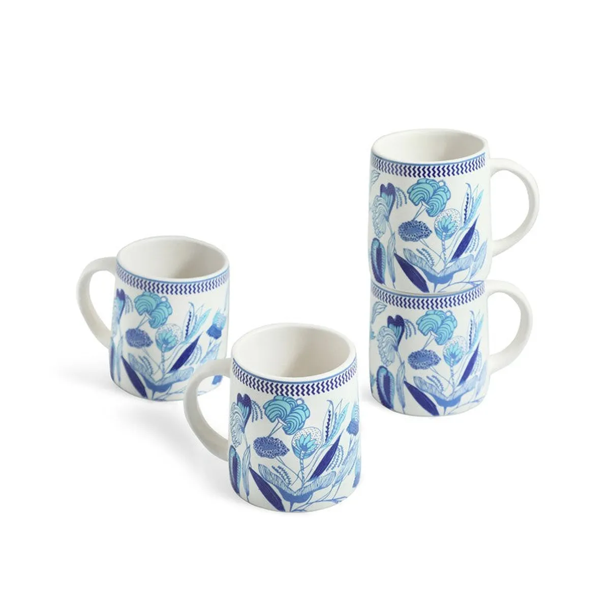 Four white and blue floral ceramic mugs arranged against a plain white background