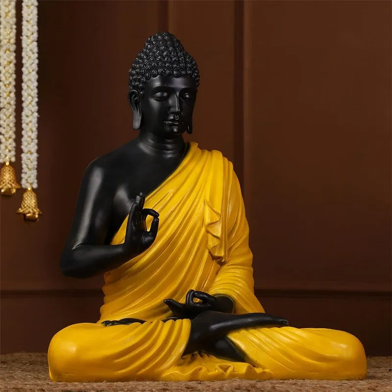 Angled view of black and yellow Buddha marble idol with draped robe