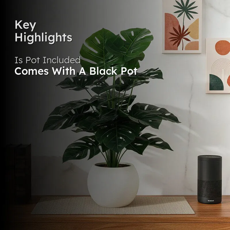 Artificial Monstera plant displayed in a room with a black pot