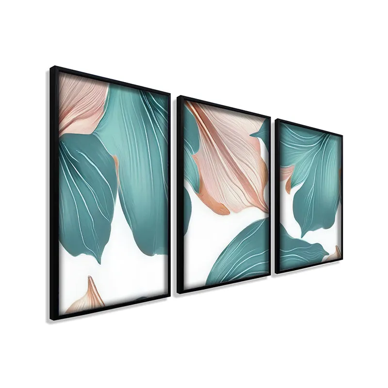 Angled view of three framed floral wall art pieces with pastel leaves