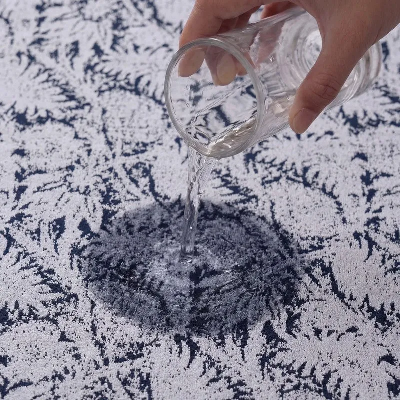 Water being poured onto the blue and white textured towel surface