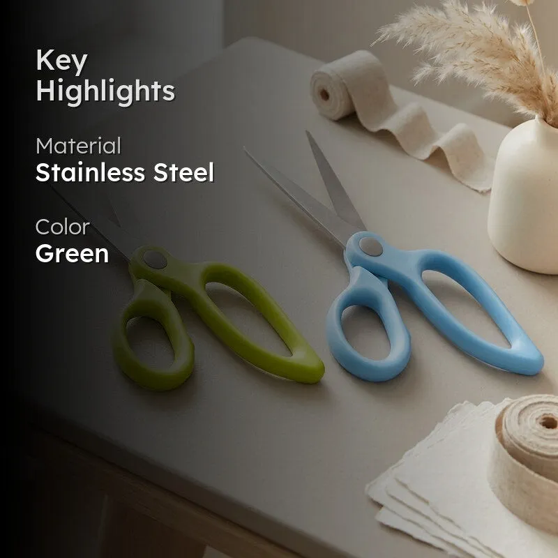 Green and blue scissors styled on a tabletop with decor