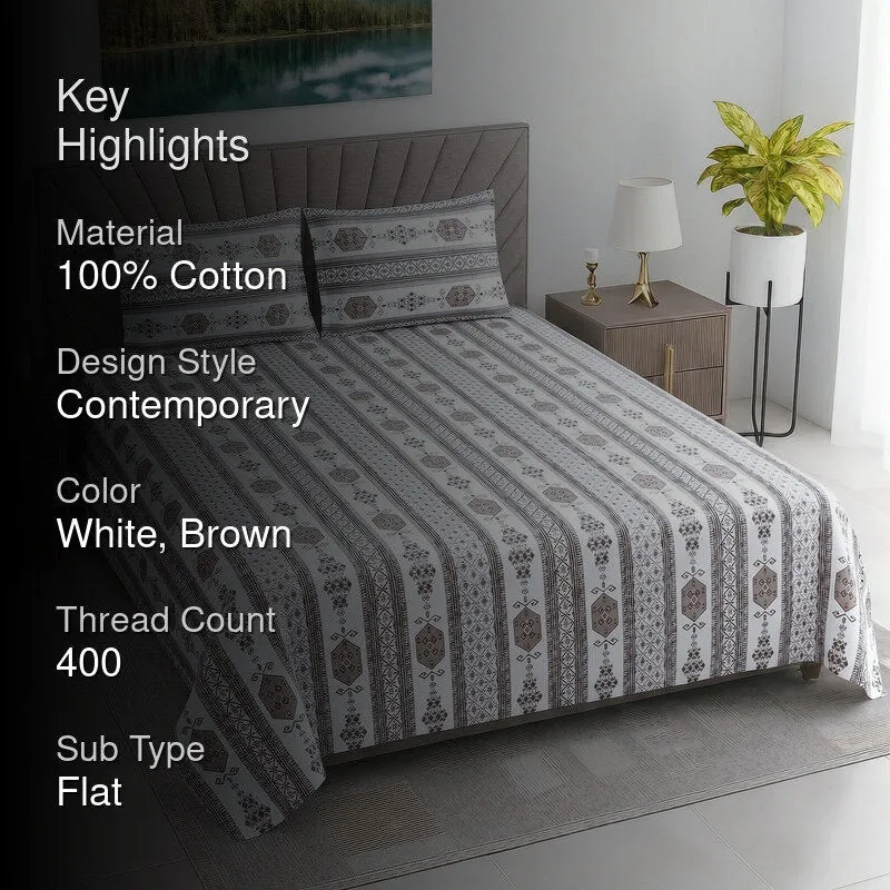 Styled bedroom with the white and brown geometric bedsheet on a taupe upholstered bed.