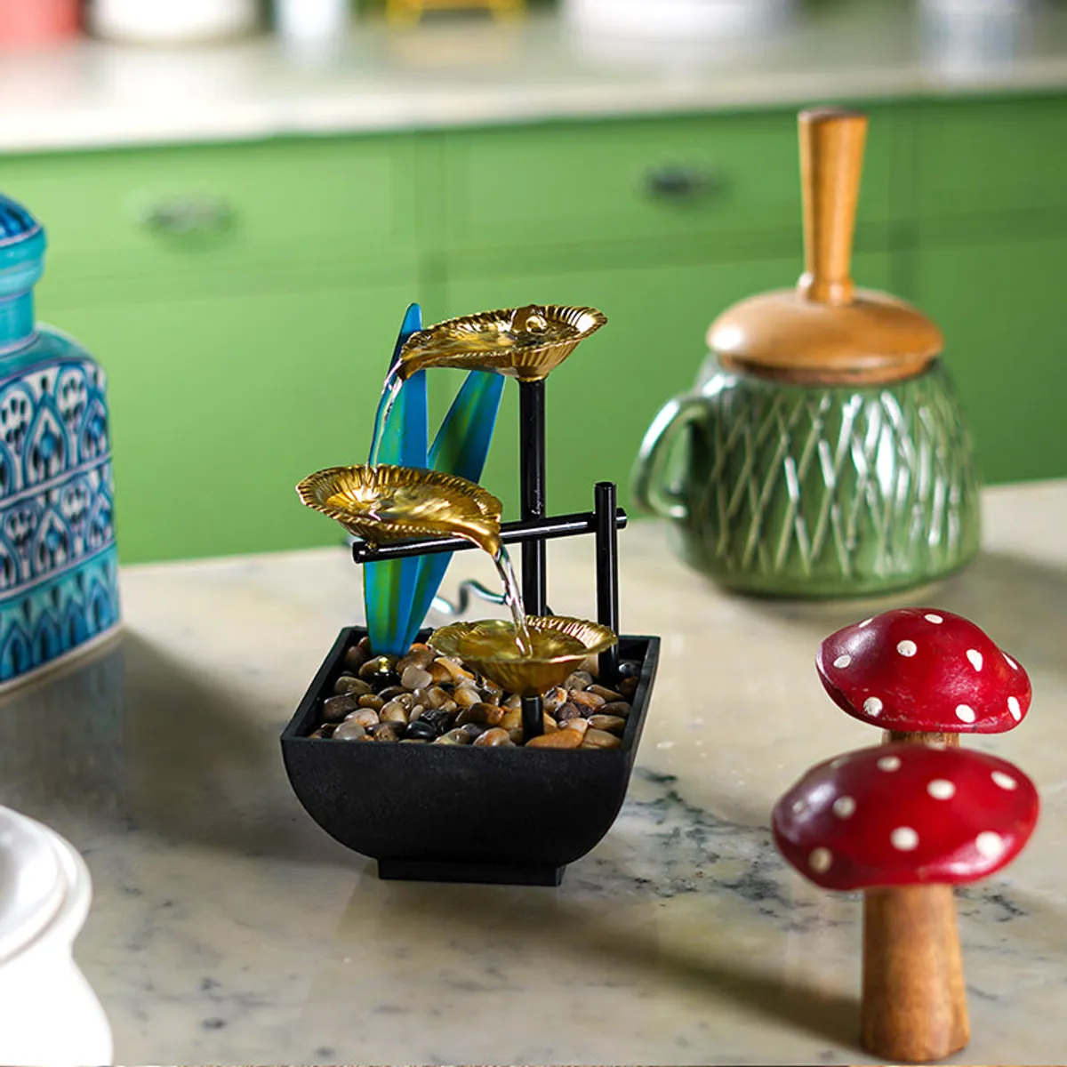 Compact gold lily pad fountain styled on a marble counter