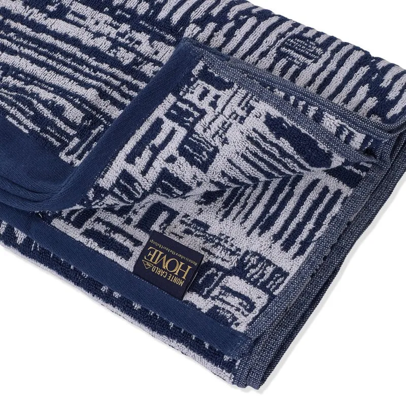 Close-up of the blue cotton bath towel with border and brand label