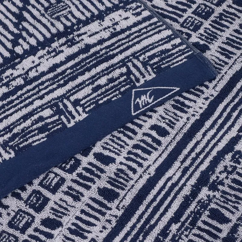 Detailed close-up of the blue and white woven bath towel texture