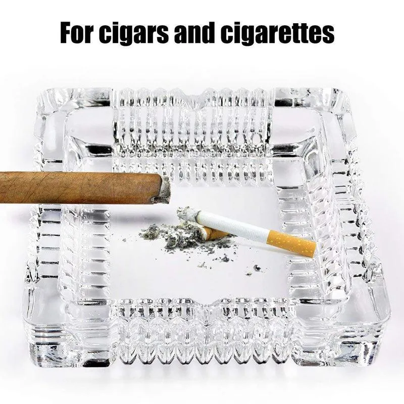 Top view of a transparent glass ashtray holding a cigar and cigarette
