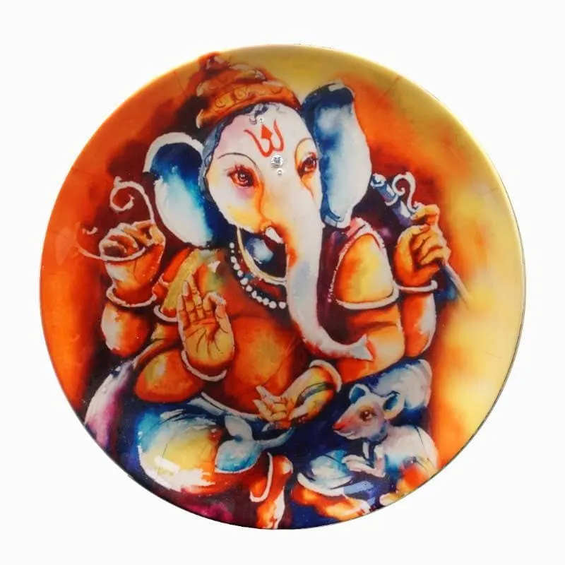 Close-up of round plate with vibrant Ganesha illustration in orange and blue