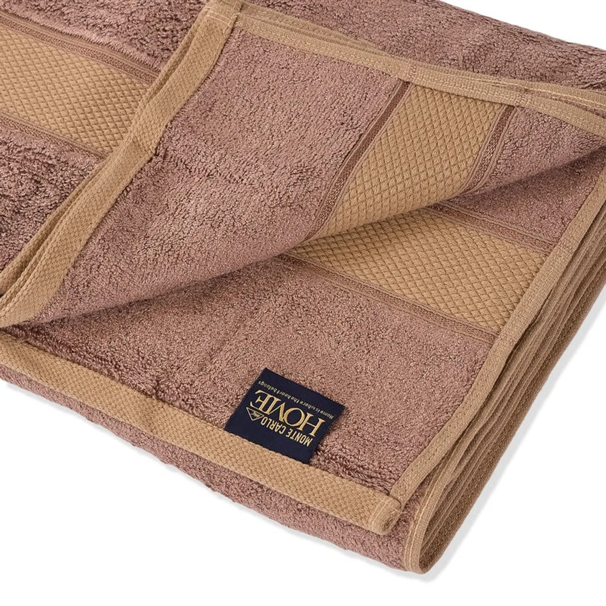 Close-up of the towel's soft pile, bands and stitched edging