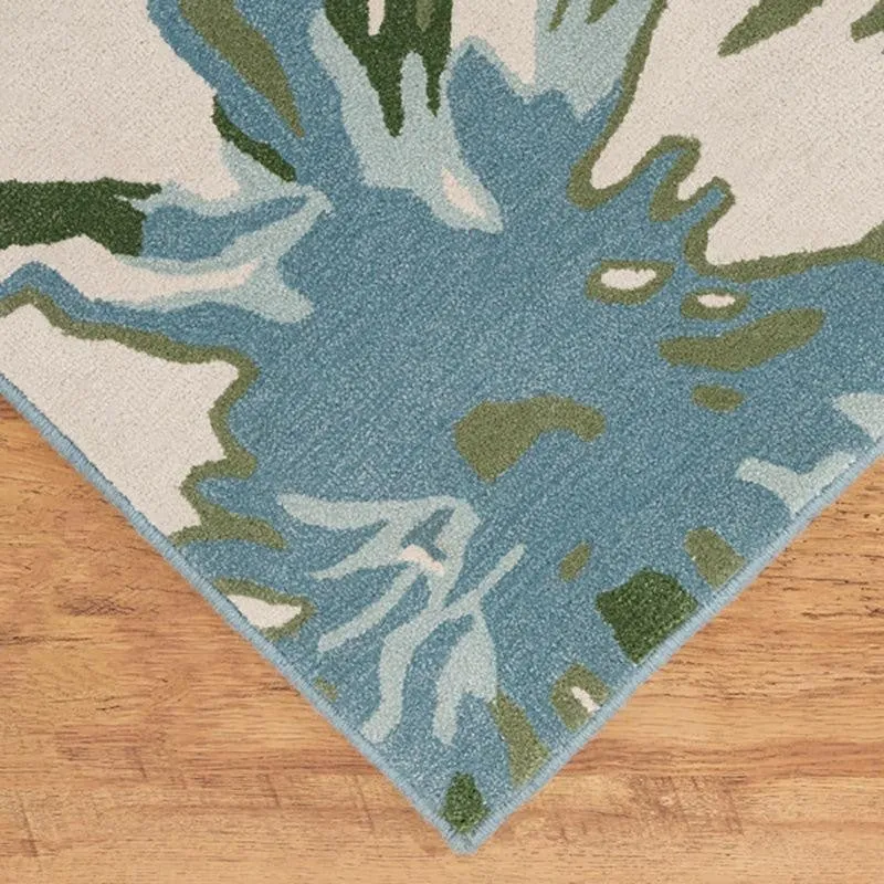 Close-up of carpet corner showing blue floral pattern