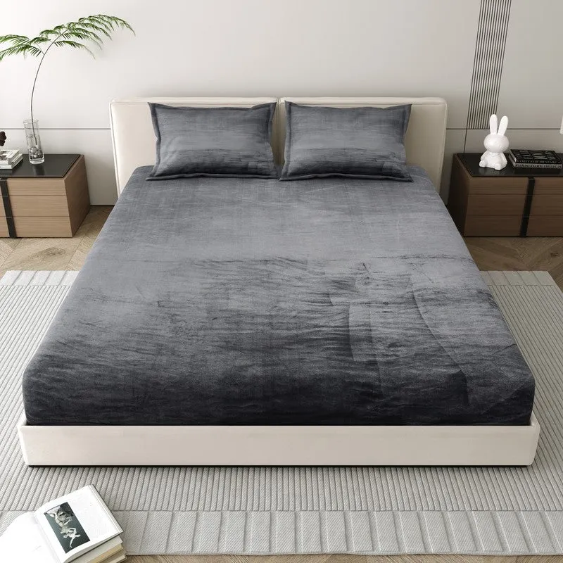 Front view of a black and grey bedsheet on a double bed with matching pillow covers