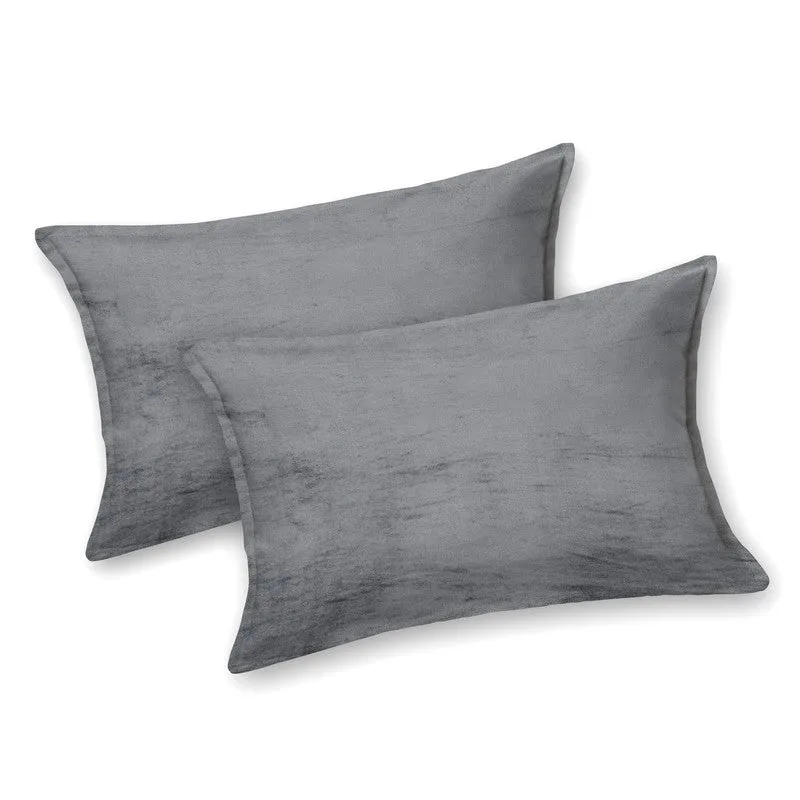 Two matching black and grey pillow covers on a white background