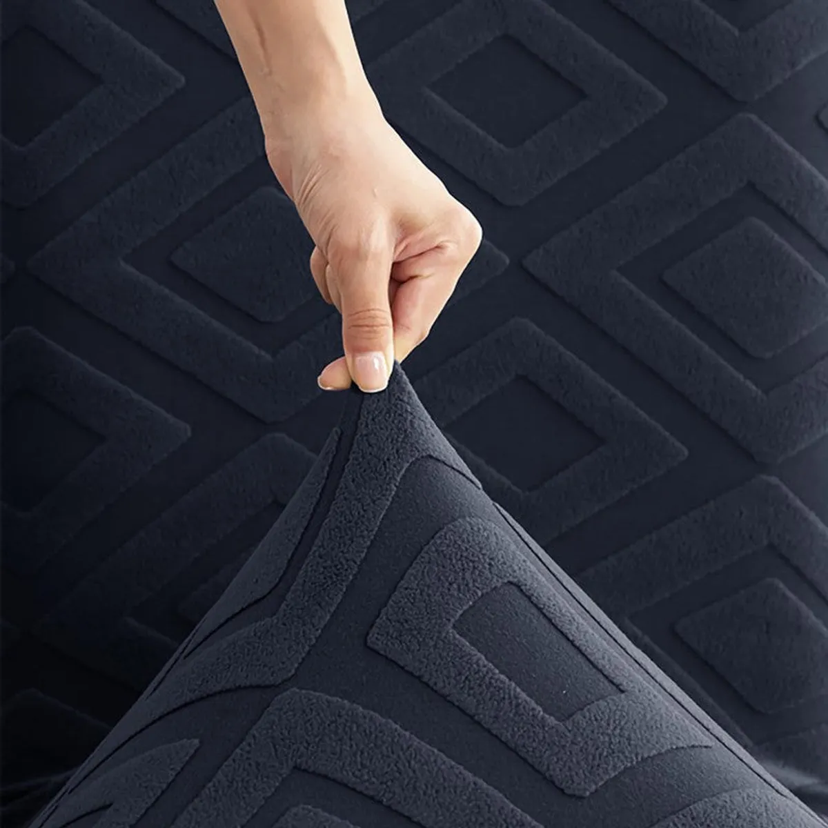 Close-up of stretchable black geometric chair cover fabric