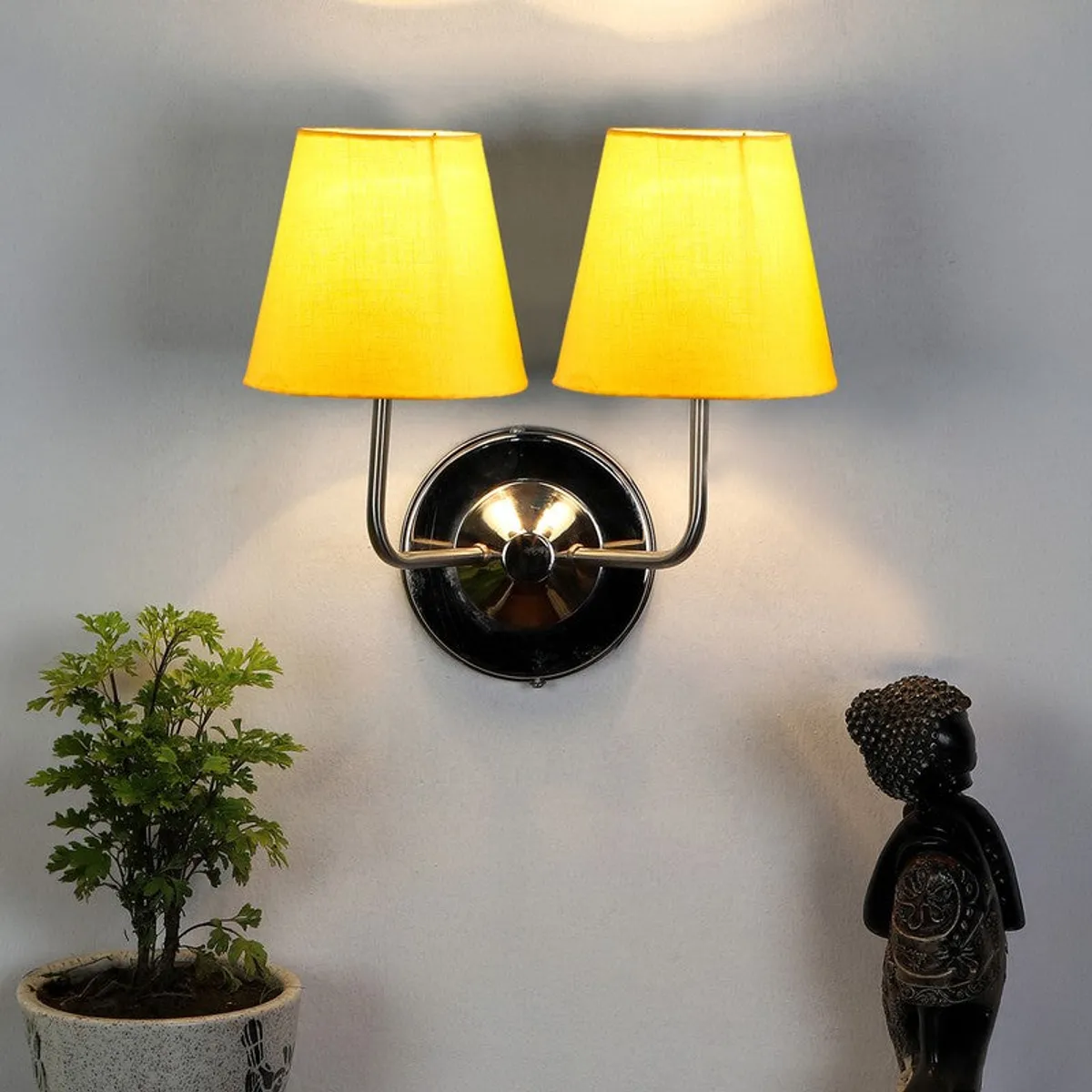 Yellow shade wall lamp casting warm light on a wall