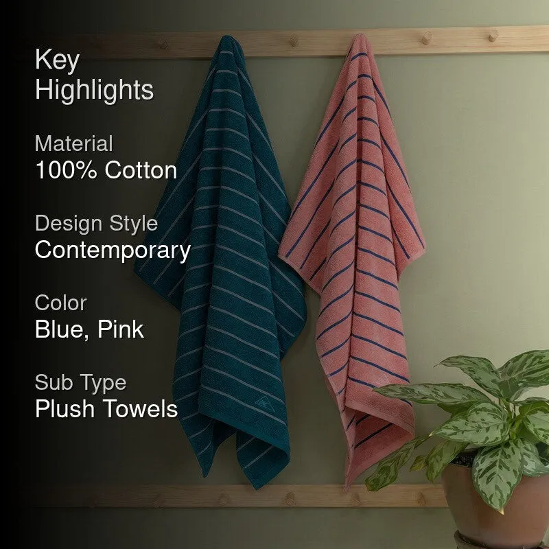 Blue and pink striped bath towels hanging beside a potted plant